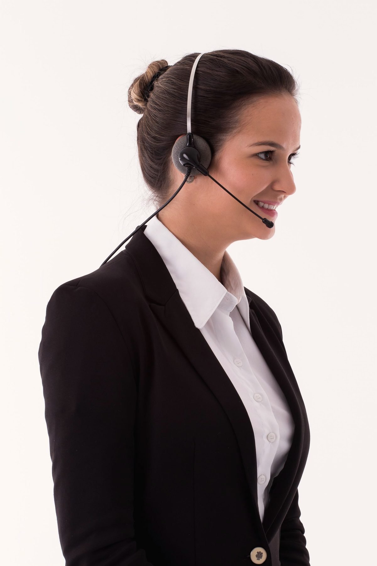 An operator in a dark blazer wearing a headset.